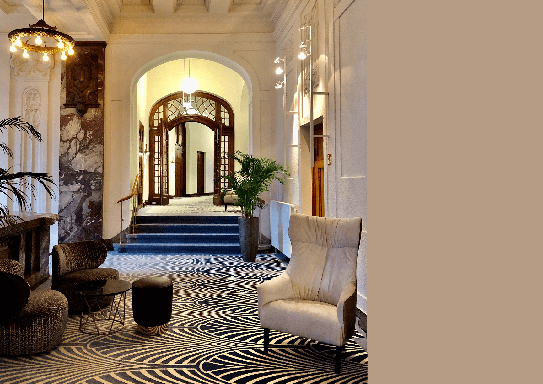 interior design of a hotel hallway with a wooden stained glass arch and marble accent wall