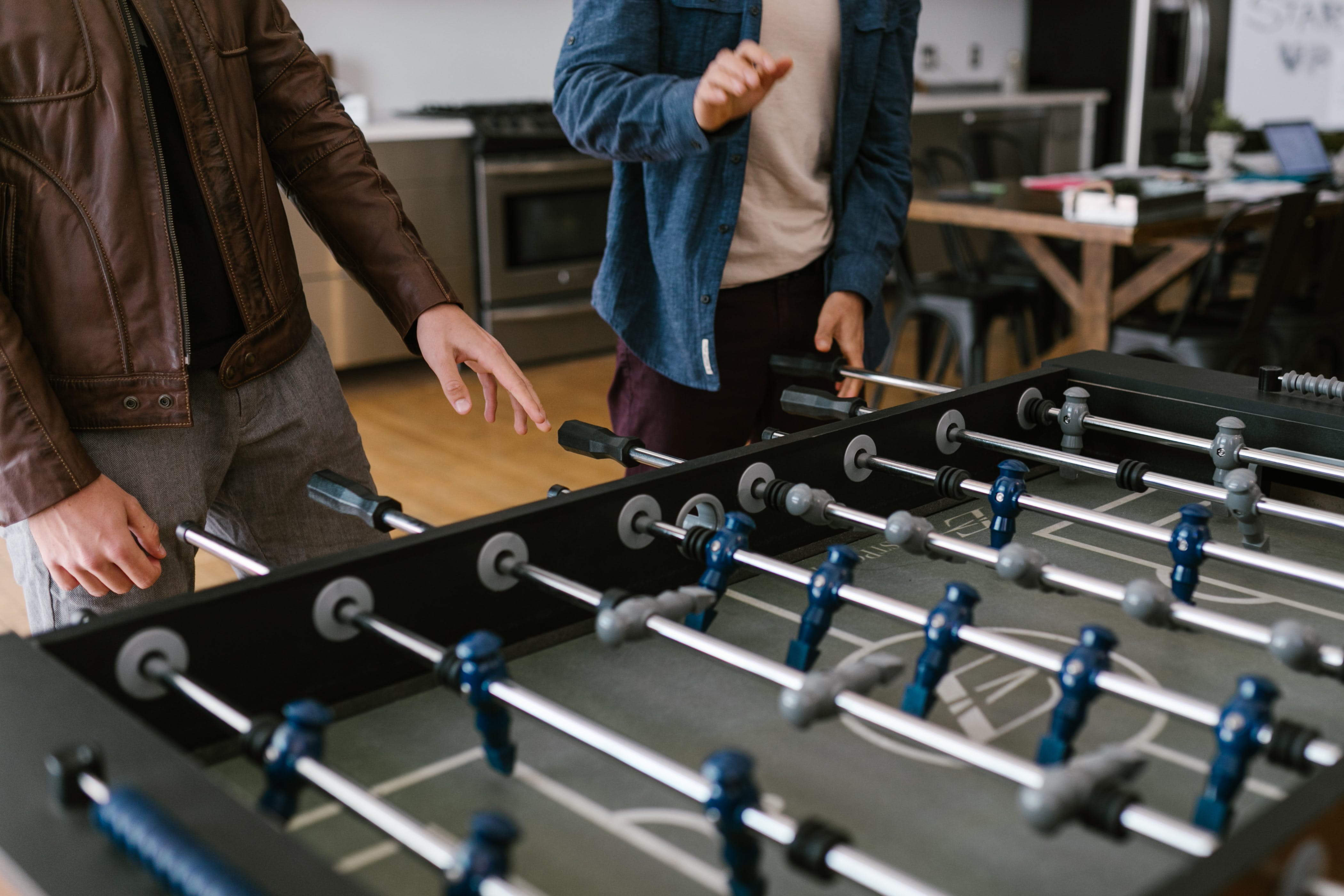 Free Friends Playing Foosball Stock Photo